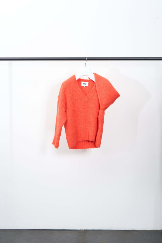 MEMORI SWEATER in bright chili pepper orange with a large v-neck, made from fluffy alpaca yarn.