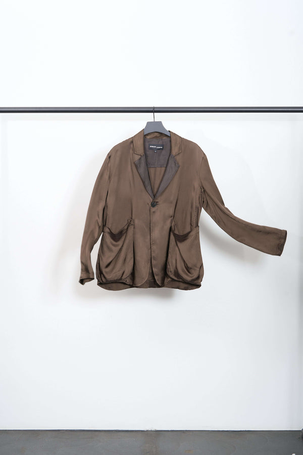 SAG BLAZER relaxed blazer with contrasting lapels and large front pockets hanging on a rack.