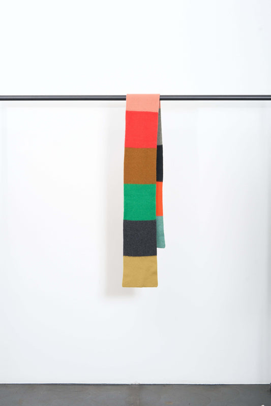BRUSHED COLOURBLOCK SCARF hanging display showcasing vibrant colored blocks in soft lambswool.