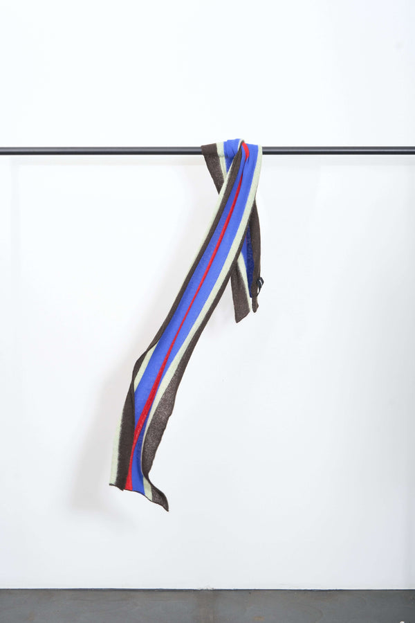 Stylish TOP-VIEW SCARF hanging on a rack, showcasing its vibrant color stripes and luxurious texture.