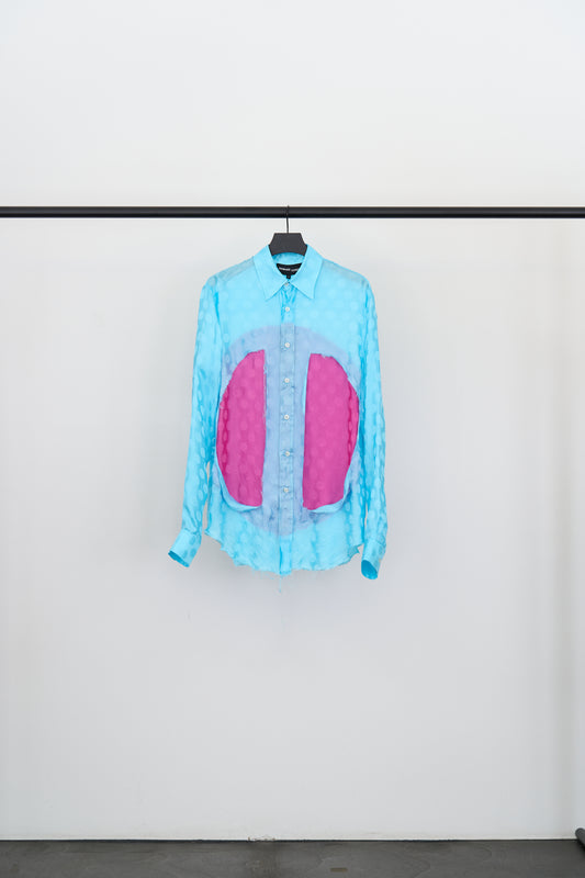 CLASSIC LUNG WINDOW SHIRT in turquoise with magenta panels and tonal dot detailing on a hanger.