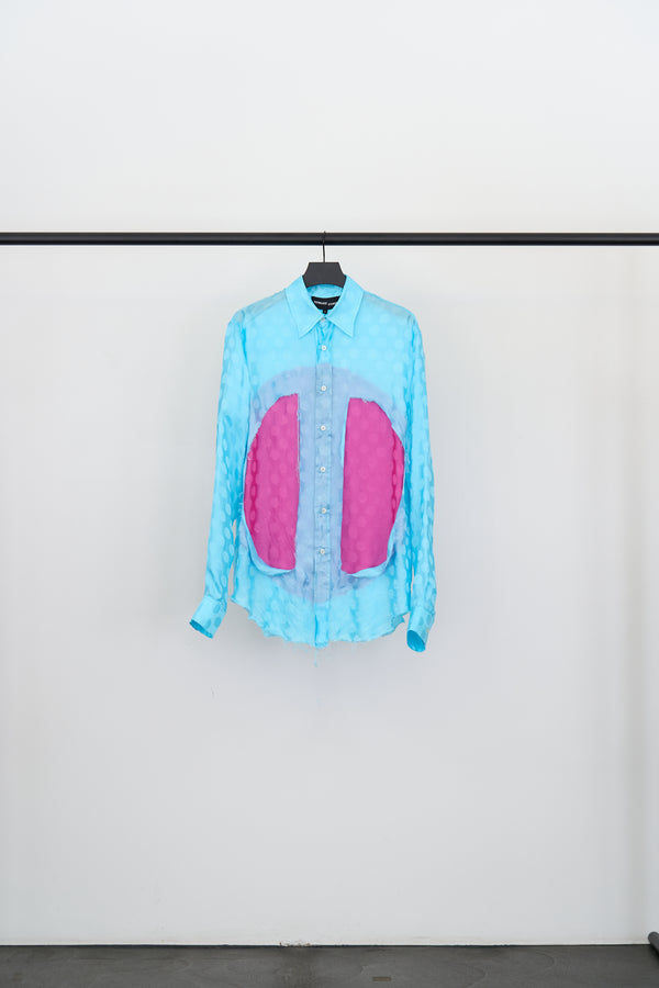 CLASSIC LUNG WINDOW SHIRT in turquoise with magenta panels and tonal dot detailing on a hanger.