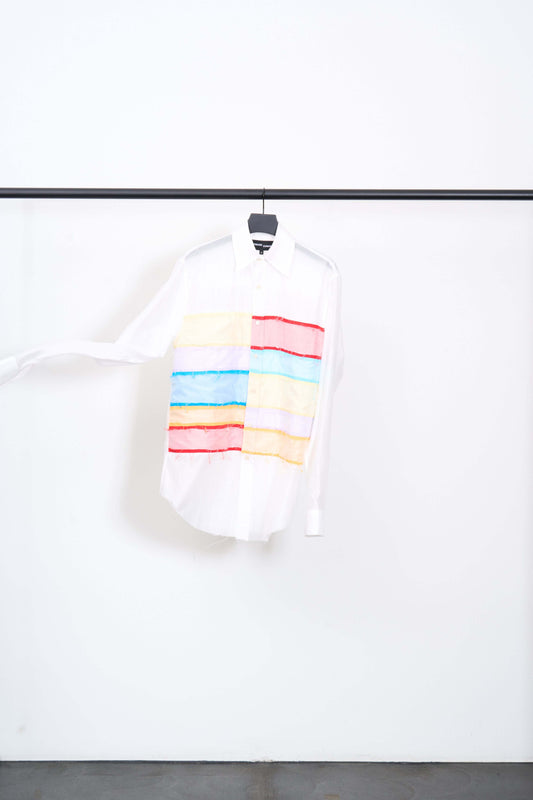 COLLAGE HEART THROB SHIRT featuring colorful blocks of fabric on a white background, hanging on a rack.