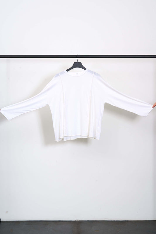 MUL LONGSLEEVE TEE displayed on hanger, showcasing its semi-transparent fabric and decorative stitching.