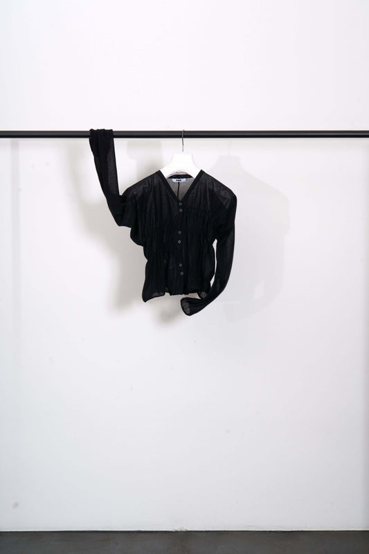OBORO CARDIGAN hanging on a rack, featuring a cropped fit and ultra-soft luxury Makò cotton.