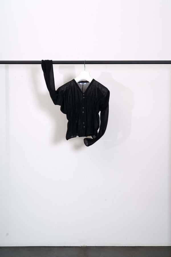 OBORO CARDIGAN hanging on a rack, featuring a cropped fit and ultra-soft luxury Makò cotton.
