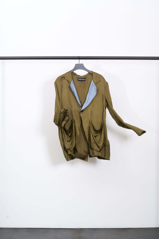 SAG BLAZER hanging on a rack, featuring khaki and blue tones in soft viscose twill material.