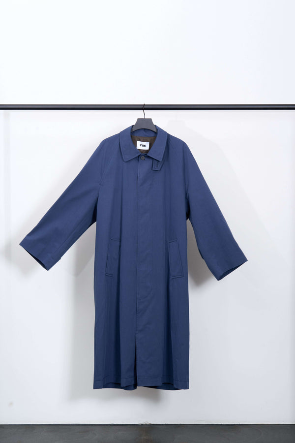 TSUYU TRENCH COAT hanging, showcasing its blue color and stylish design for rainy season wear.