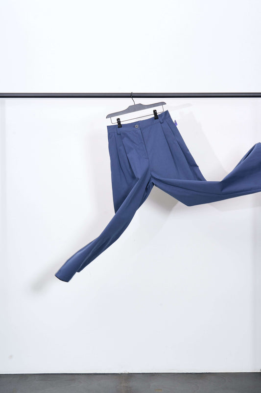 ONEMU PANTS displayed hanging, in dark blue color, made of 68% cotton and 32% polyamide.