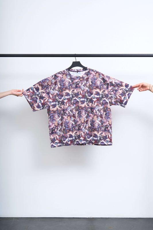 FALLEN ANGEL TEE displayed on a hanger, showcasing chaotic Renaissance inspired artwork in an oversized silhouette.