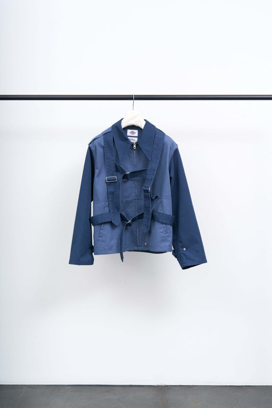 DICKIES HARNESS JACKET displayed on a hanger, showcasing its unique design with straps and layered construction.
