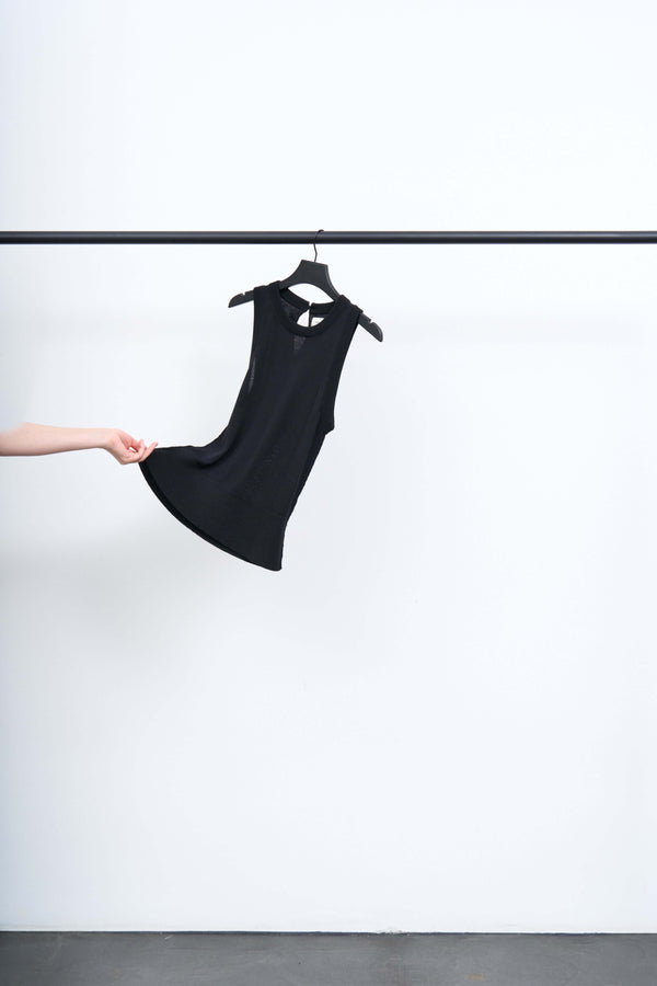 APPOINTMENT TOP hanging on a rack, showcasing its sleek design and keyhole opening at the back.