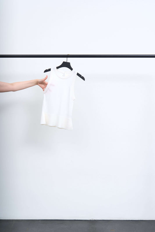 APPOINTMENT TOP displayed on a hanger, showcasing its minimalist design and soft fabric.