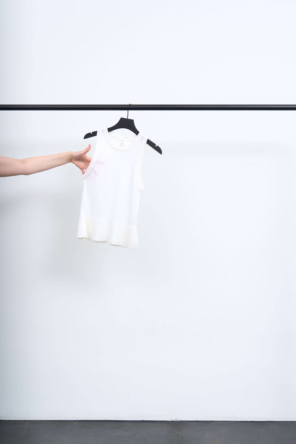 APPOINTMENT TOP displayed on a hanger, showcasing its minimalist design and soft fabric.