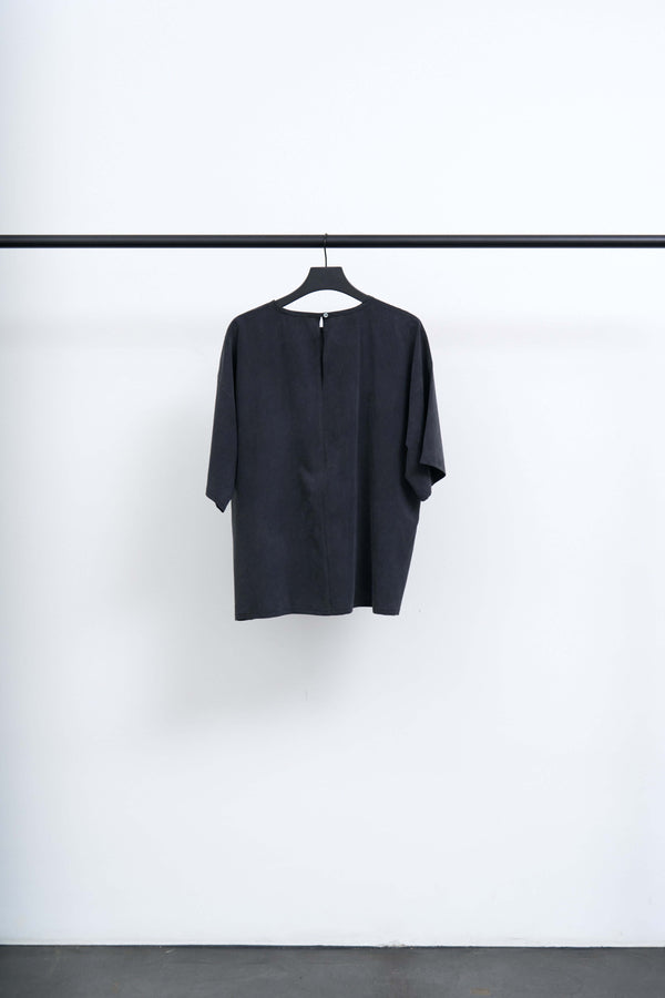 JAKO - LIGHT TENCEL T SHIRT BLOUSE hanging on a hanger against a minimalistic background