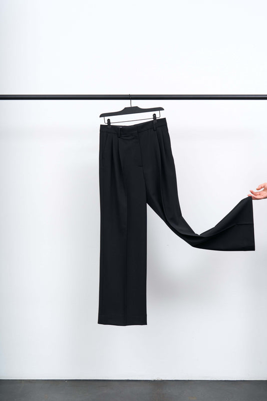 Darcey Wool Trousers showcased on a hanger, highlighting their structured design and elegant silhouette.