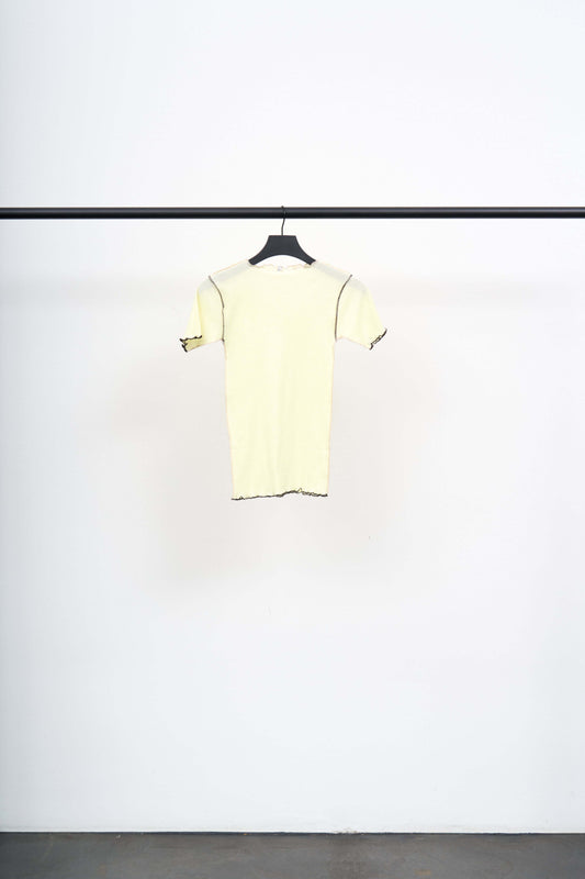 VEIN TEE SHIRT hanging on a black rack, showcasing its lightweight design and exposed contrast stitching.