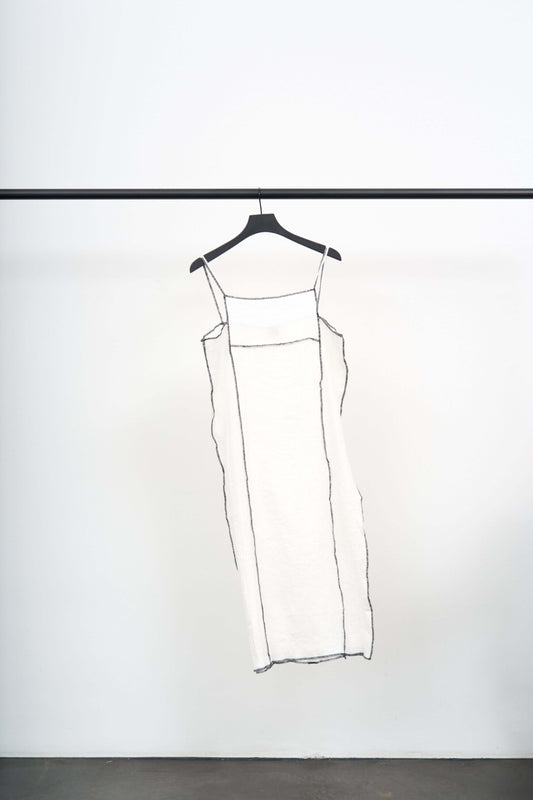 SHOK SQUARE DRESS hanging on a black hanger against a white background, showcasing its crinkled linen blend texture.